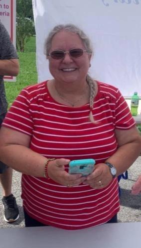 Volunteer checking runners in on a phone at a race