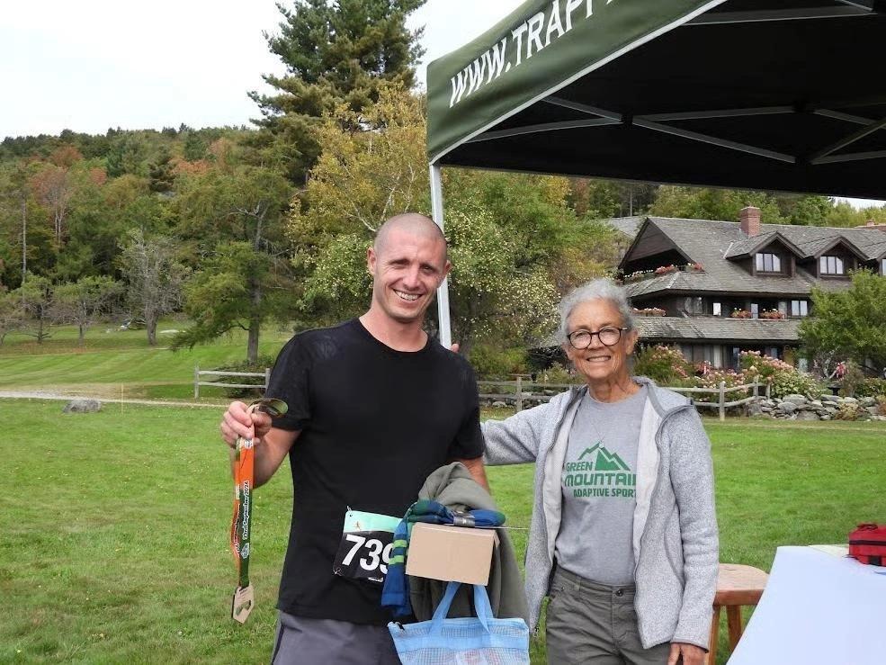 Cynthia Needham with a finisher under the Trapp Cabin Trail Races tent