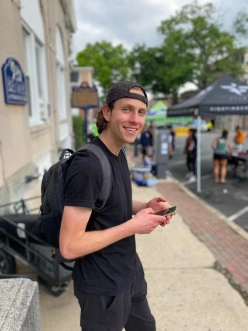Ian Campbell of Run The Day checking live results on his phone at a race